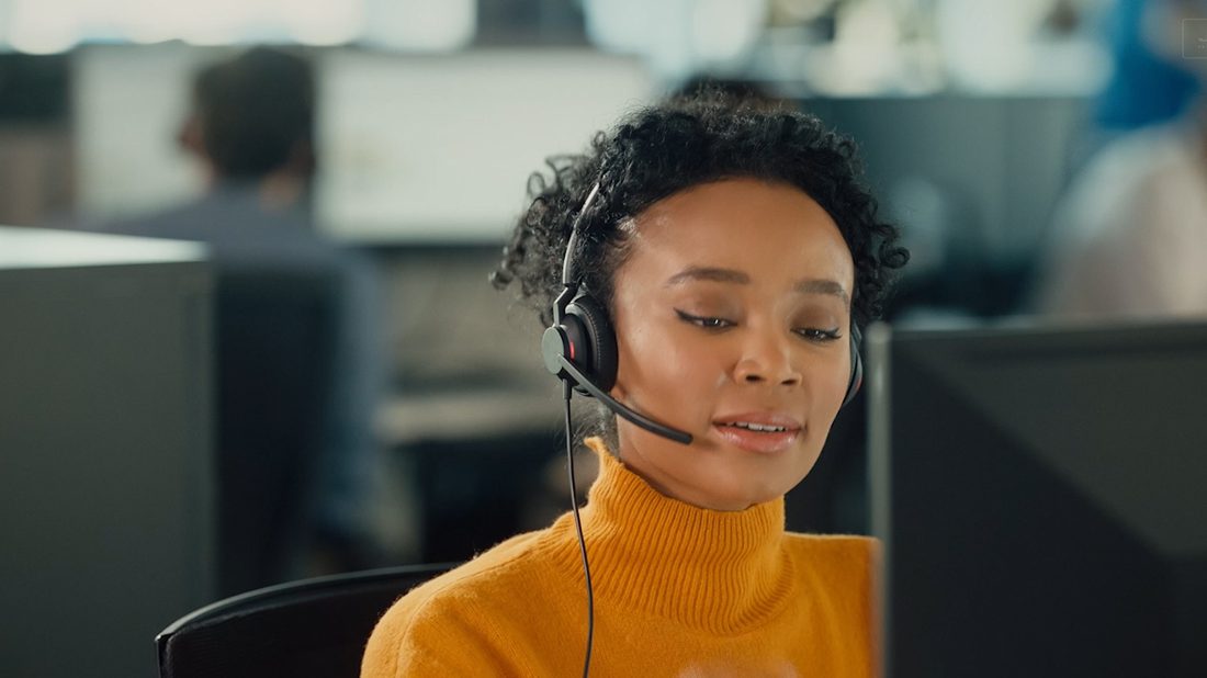 VOIP telephone system support team member on headset